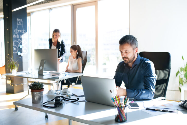 Three business people in the office working together