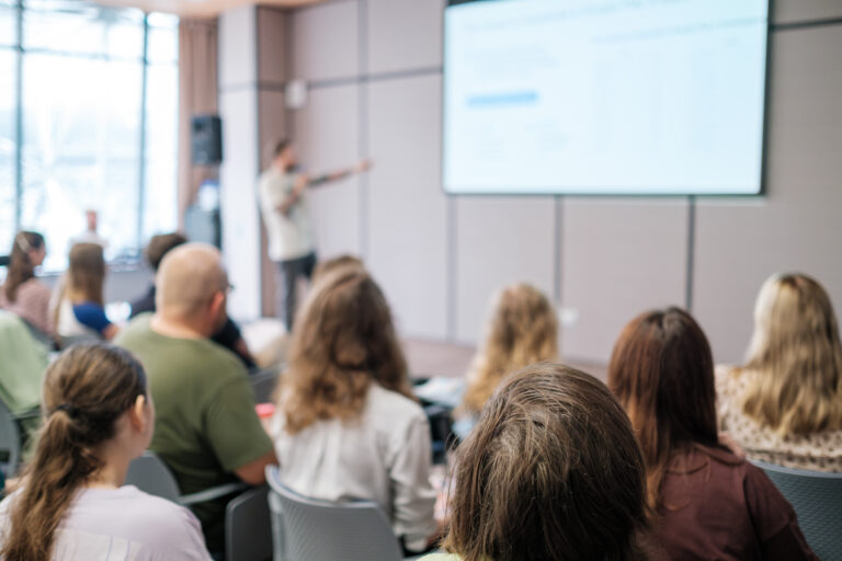 Business presentation with attentive audience in modern conference room